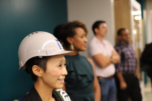A smiling woman in a construction hat