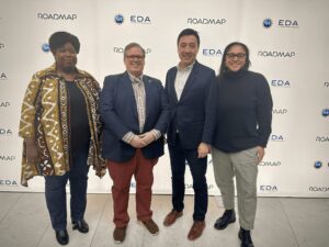 Four people standing together.