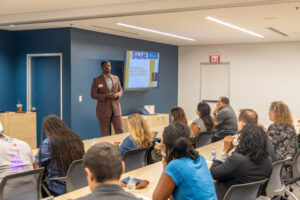 A man standing in front of a room full of students.