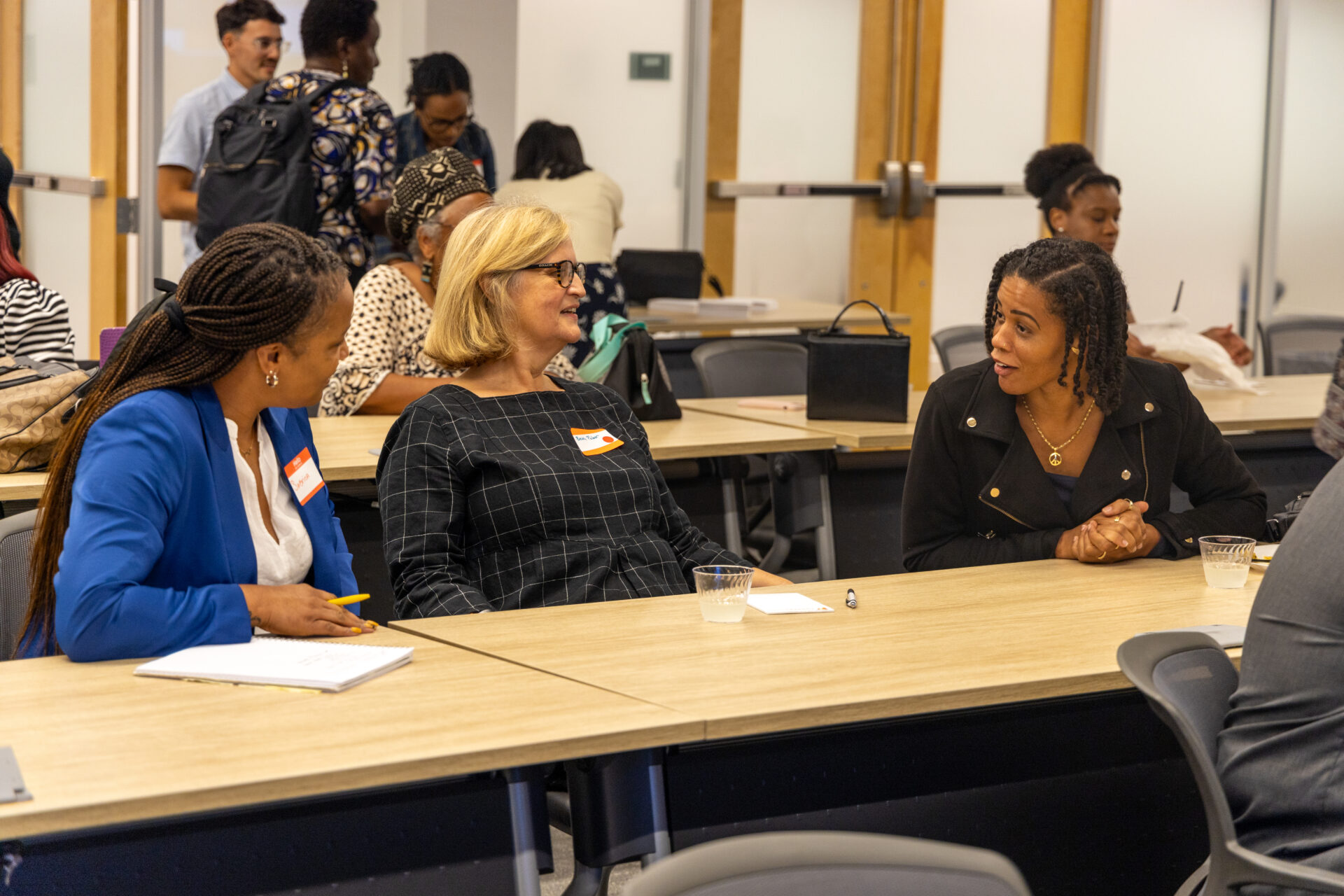 Three women sitting at a classroom table